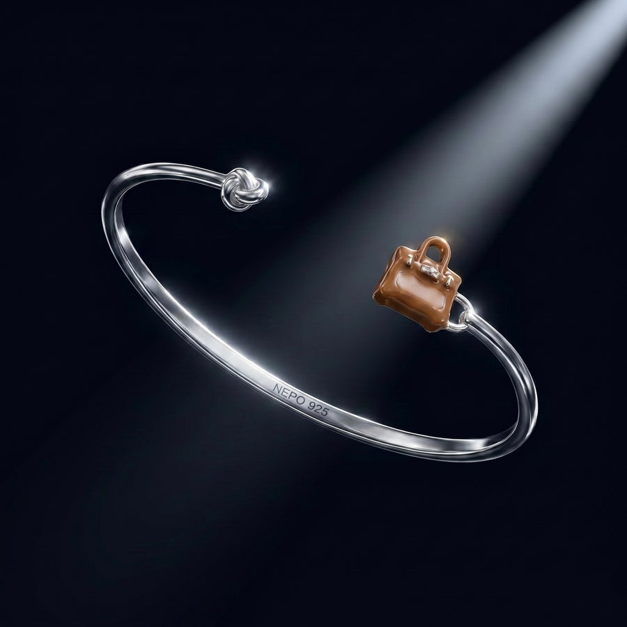 The Heiress — 925 sterling silver knot bangle with hand-painted bag charm, NEPO London