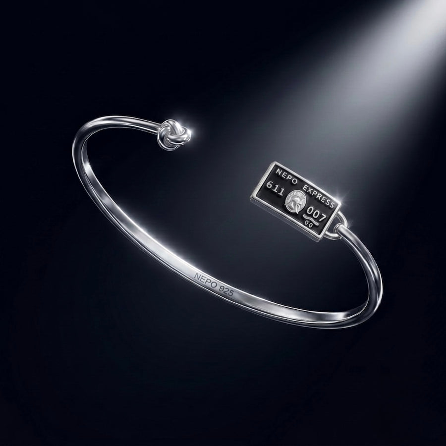 The NEPO Baby — sterling silver knot bangle with the NEPO Express card charm